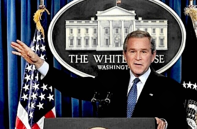 President Bush with his right arm raised