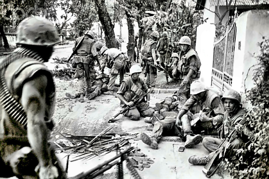 Marines in Hue City, Vietnam tend to their wounded after a firefight