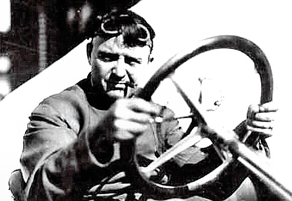 Barney Oldfield behind the wheel with his signature cigar